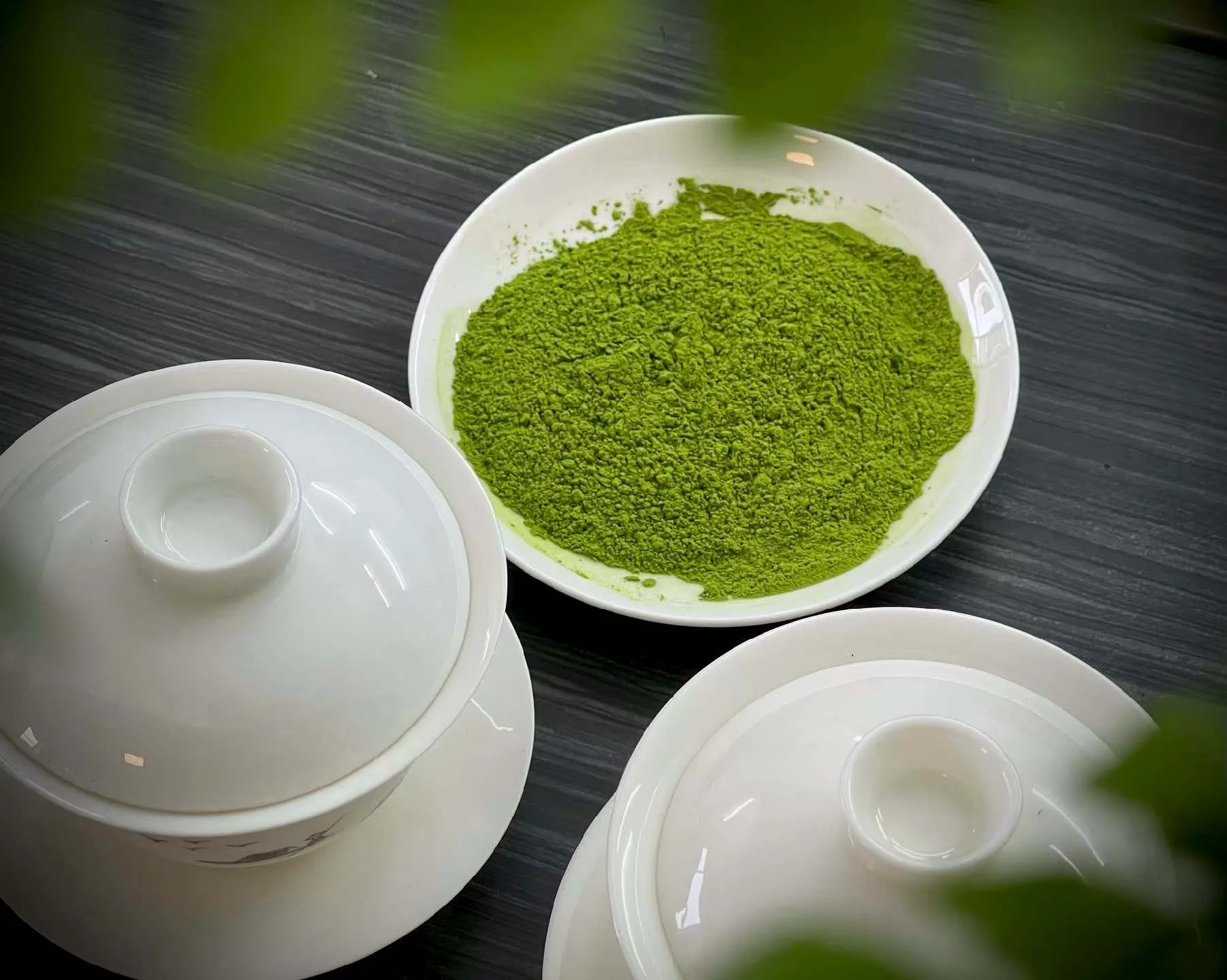 Matcha powder beside a gaiwan, real shot